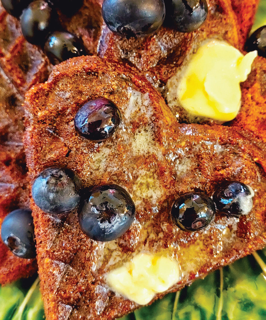 Buckwheat waffles with butter, syrup and blueberries