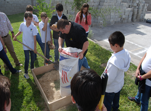 Antonio teaches young people Biointensive farming techniques